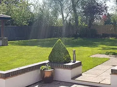 Summer lawn care visit underway at a Bodmin property by Green Stripe Lawn Care